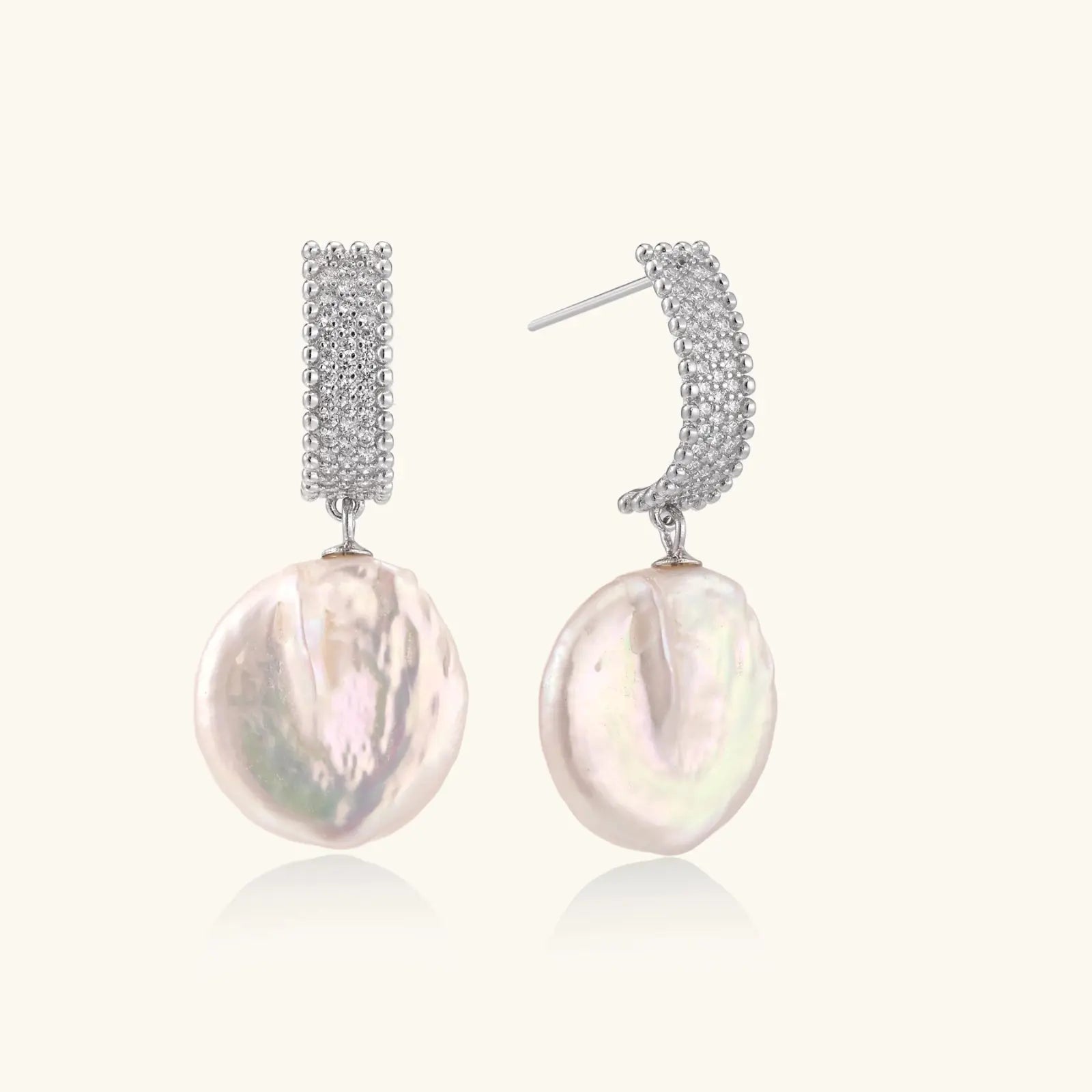 Rhodium-plated silver curved stud with pave stones and baroque pearl drop on white background