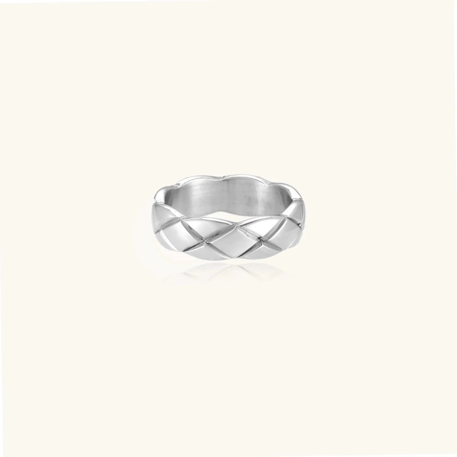 Braided stainless steel band ring with geometric interwoven strands in brushed silver finish on white background